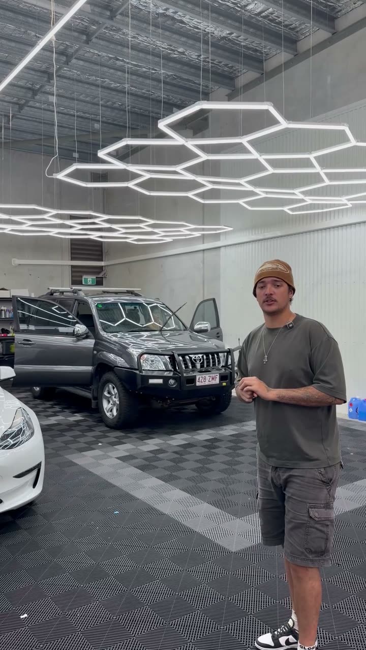 Anton with a grey Toyota Prado in the shop
