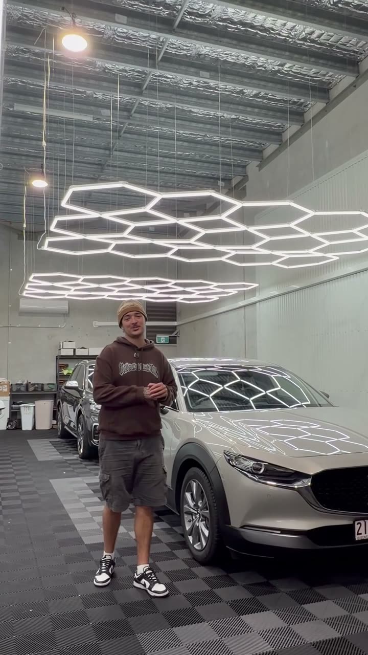 Anton with a silver Mazda CX-30 in the shop