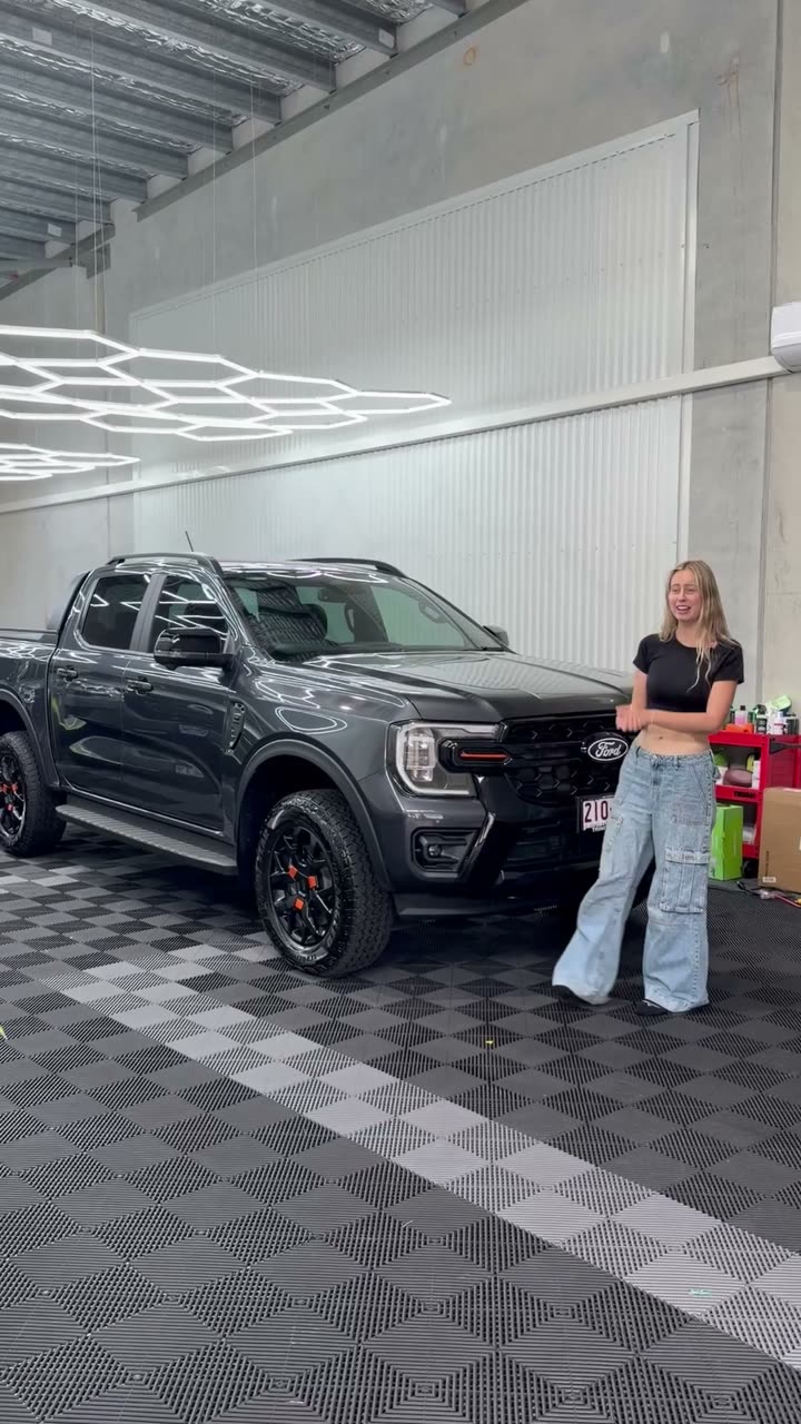 Grace with a grey Ford Ranger in the shop